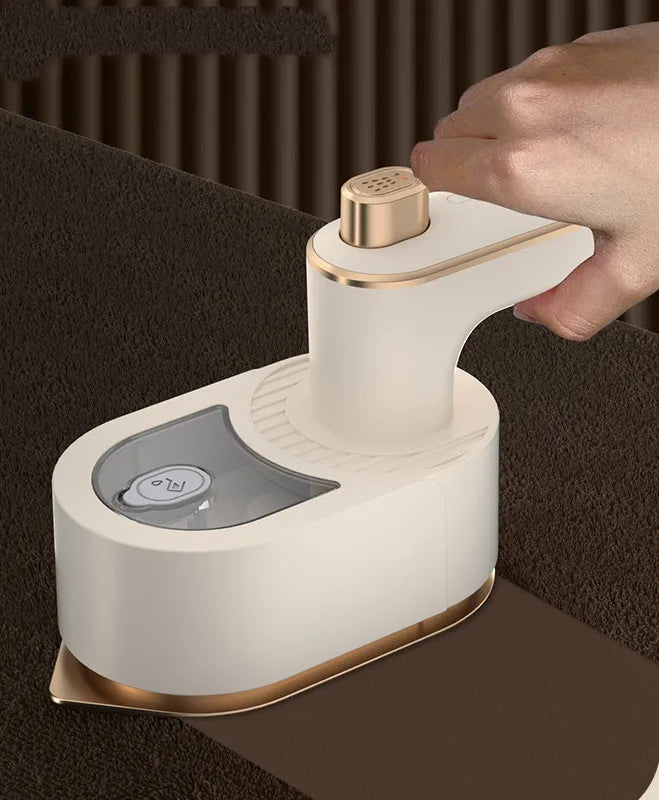Beige handheld garment steamer shown in use